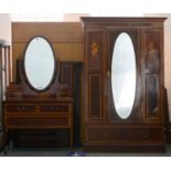 An Edwardian mahogany and inlaid bedroom suite, comprising wardrobe, dressing table with oval