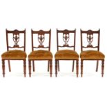 A set of four late Victorian mahogany salon chairs, c. 1900, scroll cresting, vasular splat carved