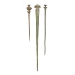 Antiquities. Three Luristan bronze pins, 1000-800 BC, 16-29.5cm l Condition evident from image;