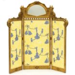 A giltwood screen, 20th c, in 19th c French style, the larger central leaf with fan shaped mirror,