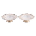 A pair of George VI silver bonbon dishes, shaped and reeded shell borders, circular pedestal