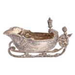 An Edwardian silver sleigh novelty sauceboat, cast with festoons and rocaille and set with a