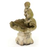 A concrete garden fountain, in the form of a faun on a shell, 75cm h Dirty from exposure in a