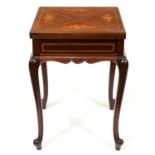 An Edwardian mahogany, satinwood, inlaid and penwork card table, of envelope type, on cabriole legs,