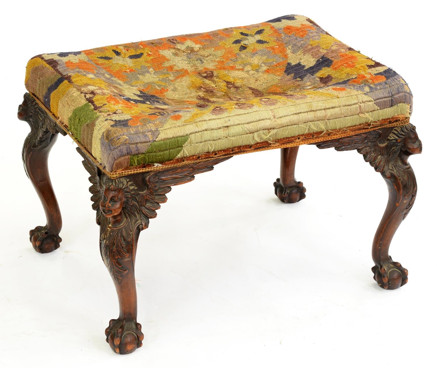 A walnut dressing stool, early 20th c, the cabriole legs carved with head and acanthus, on claw