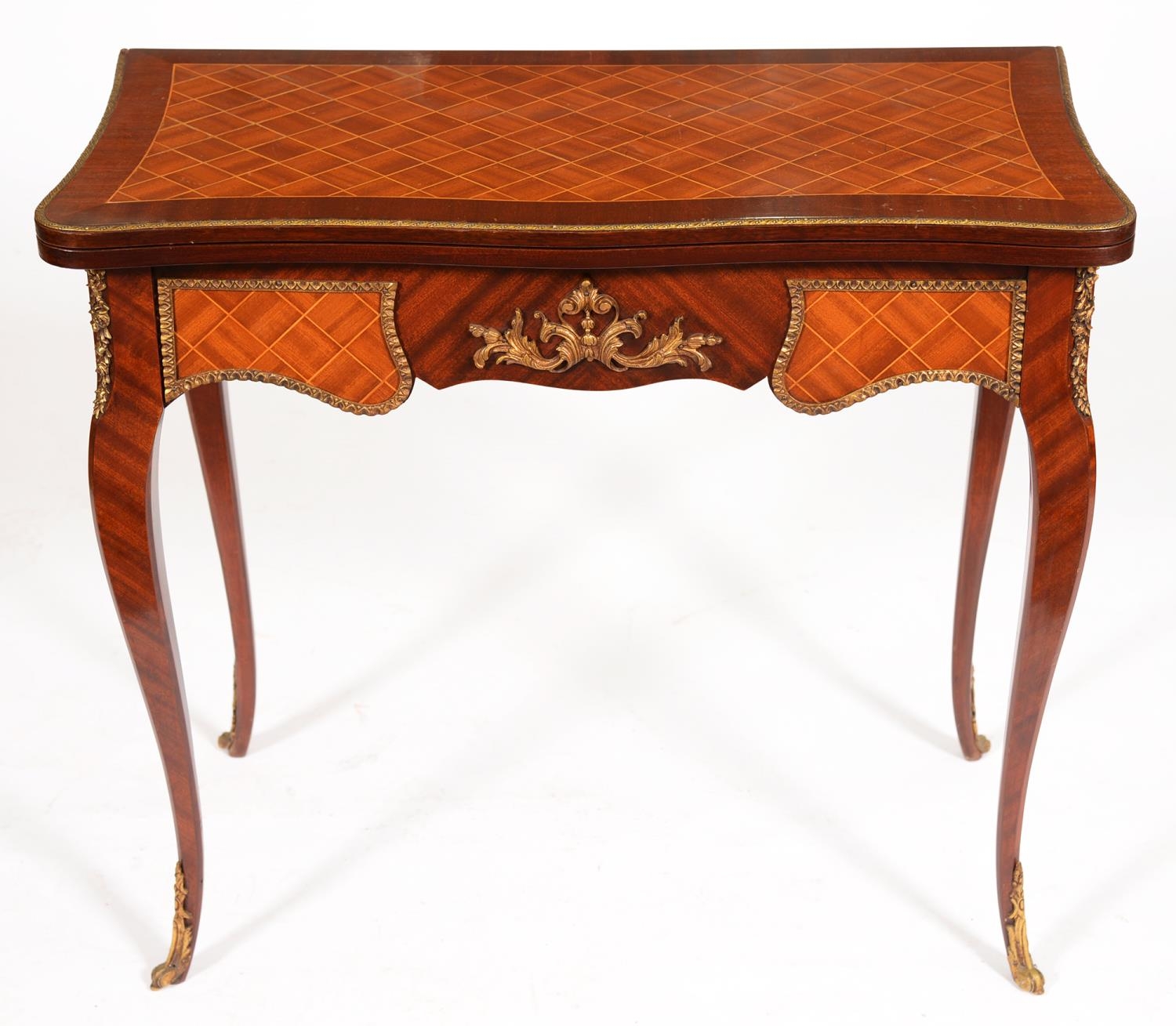 A reproduction serpentine mahogany and trellis inlaid card table, in Louis XV style, with brass
