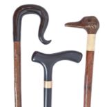 Walking sticks. A blackthorn crook, with horn handle, another, the handle carved as the head of a