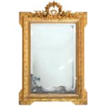 A French giltwood and composition mirror, late 19th c, in Louis XVI style, the bevelled plate in
