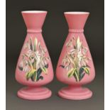 A pair of Victorian enamelled pink cased white glass vases, painted with flowers, 22.5cm h Good