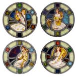 A set of four Arts & Crafts stained glass window lights, with roundels of a seated female