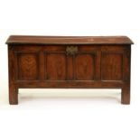 An oak chest, early 18th c, with one-piece boarded lid and four panel front, 63cm h; 44 x 122cm