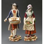 A pair of Continental porcelain figures of itinerant street vendors, 20th c, 19cm h