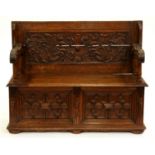 A carved oak monk's bench, early 20th c, 75cm h; 49 x 122cm Split in top