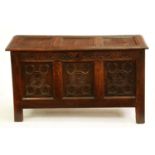 An oak chest, late 17th c, with three panel lid, the front carved with lunettes above three flower