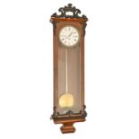 A Vienna wall clock, the enamel dial in foliate cast brass bezel, in later associated rosewood and