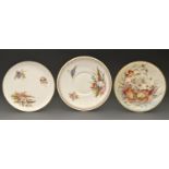 An English porcelain plate, 1893, painted with wild flowers and autumnal leaves with raised gilt