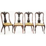 A set of four Edwardian carved mahogany chairs, with padded woolwork seat, cabriole legs Minor marks
