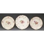 A pair of Royal Copenhagen dessert plates, 1950, painted with flowers in osier moulded border and