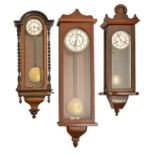 Three Vienna wall clocks, c1900, walnut and ebonised or later associated cases, pendulums, walnut