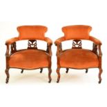 A pair of Edwardian stained wood tub chairs, with carved splats Slightly marked and scratched