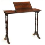 A Victorian rosewood writing table, the narrow rectangular top with adjustable flap on coupled