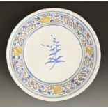 A French faience basin, 19th c, the polychrome border within blue and yellow bands, 34.5cm diam Good