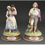 A pair of French biscuit porcelain figures of peasants, late 19th c, painted in a bright palette, on