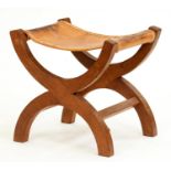 A 'Mouseman' oak X-frame stool, 1970's, lightly fumed, with tan leather sling seat, 52.5cm h, carved