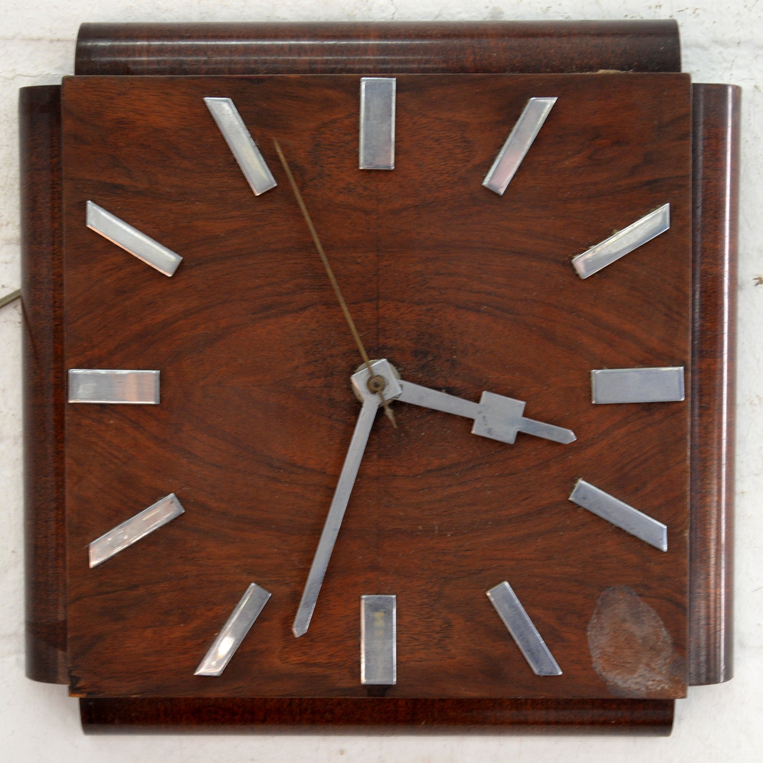 An Art Deco electric wall timepiece, with chromium plated hands and chapters