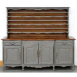 A French oak farmhouse dresser, 20th c, in mid-18th c style, later painted grey, the cupboard base