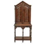 An Antiquarian taste carved oak cupboard, early 20th c, of lancet arched shape with twin panelled