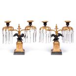 A pair of gilt and patinated bronze lustre candelabra, late 20th c, in Empire style, supported by an