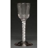 An English wine glass, c1770, the fluted ogee bowl on single series opaque twist stem and conical