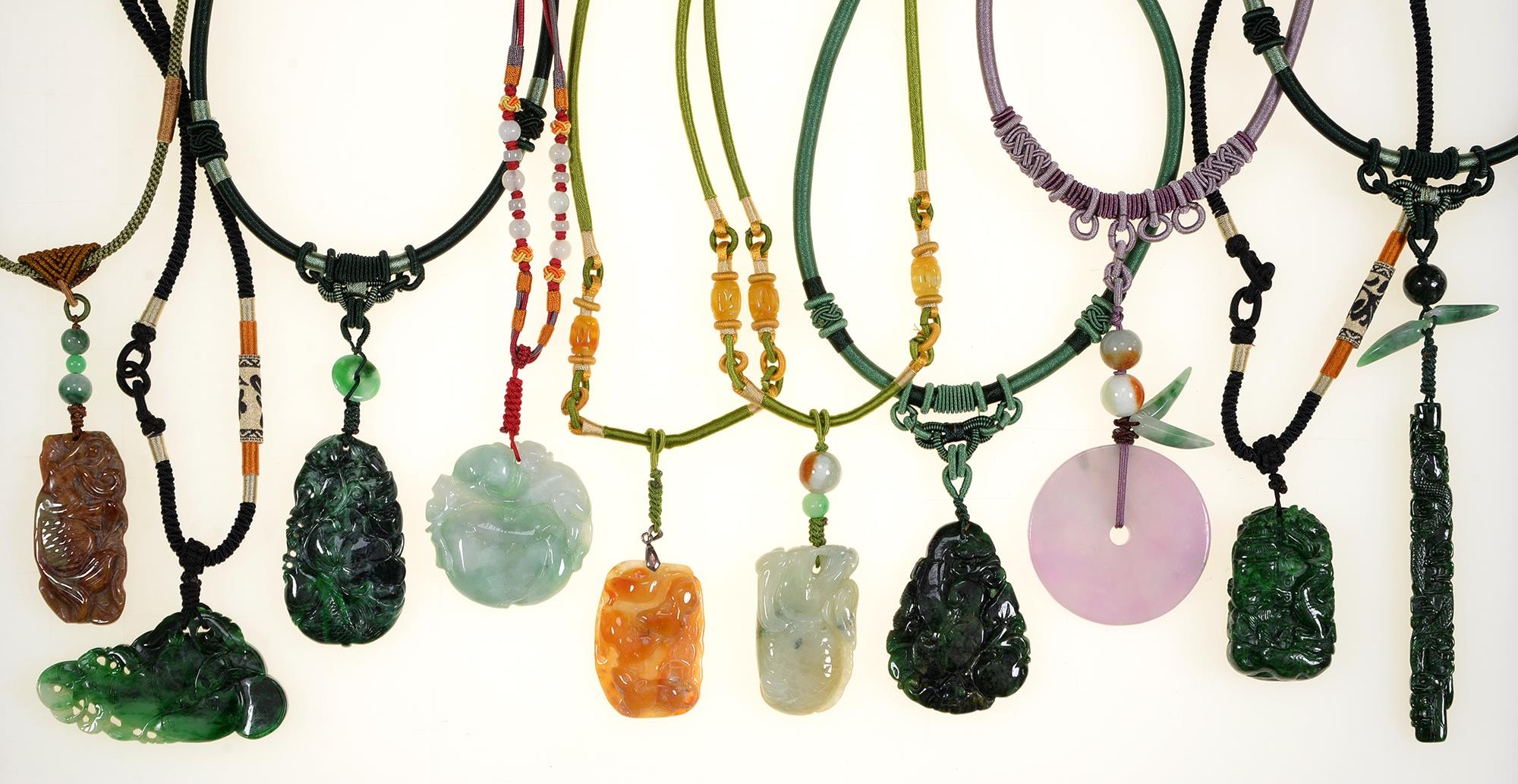 Miscellaneous Chinese carved jade pendants and hardstone beads on silk covered necklaces, late