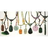 Miscellaneous Chinese carved jade pendants and hardstone beads on silk covered necklaces, late