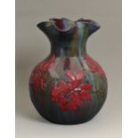 An Elton ware poinsettia vase, c1900, of bulbous form with wavy neck, 30cm h Several tiny rim