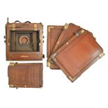 An English mahogany and brass folding plate camera, The New King, c1902, half plate, with trade