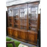 A mahogany bookcase, of breakfront form, fitted with adjustable shelves enclosed by glazed doors,