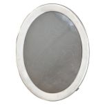 A George V oval silver photograph frame, backed on oak, 25cm, marks rubbed, Birmingham 1921 Minor