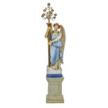 An early 20th c painted composition statue of an angel, on associated plinth, 205cm h including