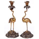 A pair of French gilt and patinated bronze crane candlesticks, late 19th c, the gilt bird gorged