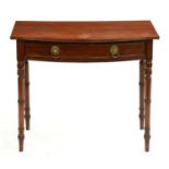 A George IV bow fronted mahogany side table, the finely figured top with drawer, on ring turned