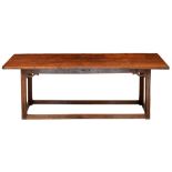 An oak table, early 19th c, the three plank top with cleated ends, on associated frame with