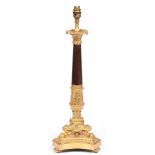 A French ormolu and patinated lamp, 20th c, in Empire style, the acanthus clad pillar on three