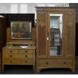 An oak two-piece bedroom suite, early 20th c, wardrobe 202cm h; 167cm l Silvering of mirror on
