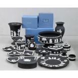 An extensive collection of Wedgwood black jasperware, including a footed bowl, vases, pin trays,