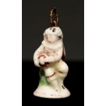 A St James porcelain seal, c1755, in the form of a seated musician in a ruff playing the hurdy-