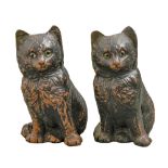 A pair of Bretby black painted earthenware models of glass-eyed cats, c1900, 18cm h, impressed