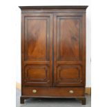 A mahogany wardrobe, with panelled doors, on ogee feet, with ivorine trade label for Henry Barker