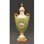 A Coalport vase and cover, c1910,  of shield shape, painted with a landscape in raised gilt